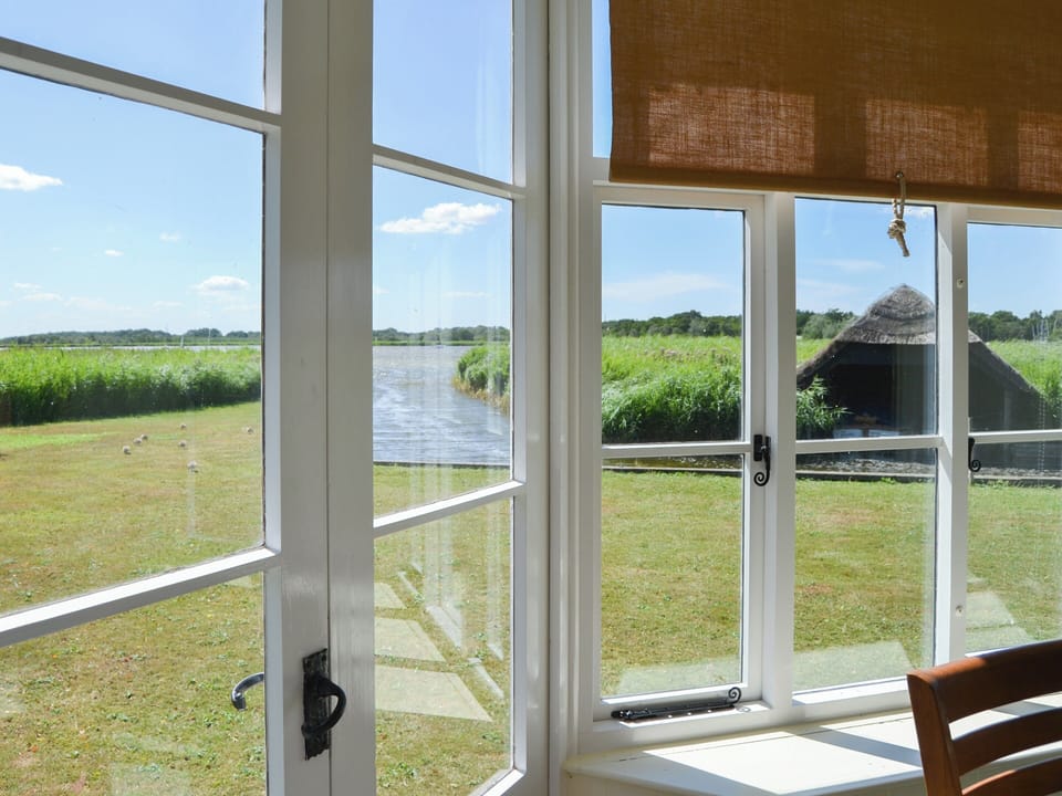 Sunny conservatory with double doors to the waterside garden | The Studio, Hickling