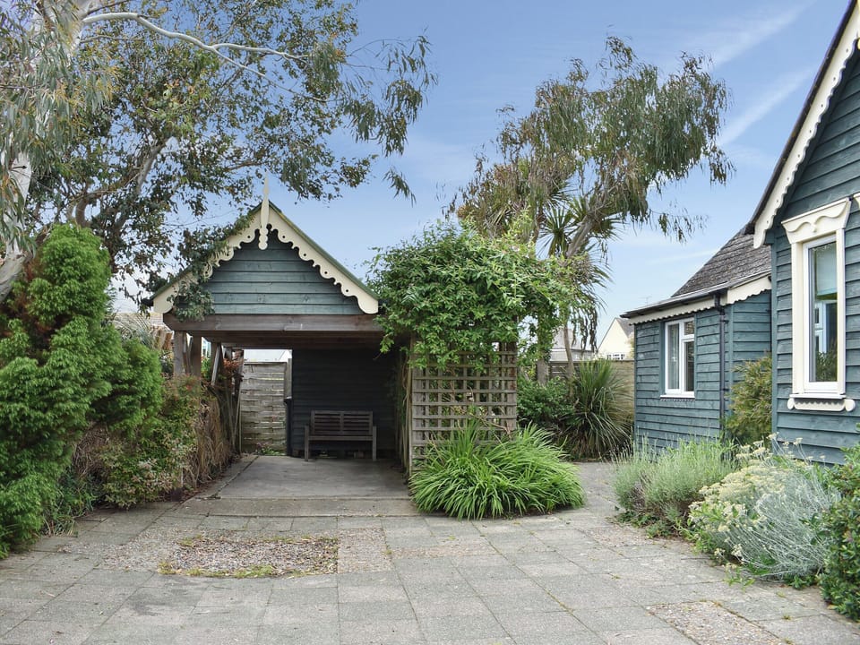 Paved driveway with sheltered seating area | Cockle Cottage, Elmer, near Middleton on Sea