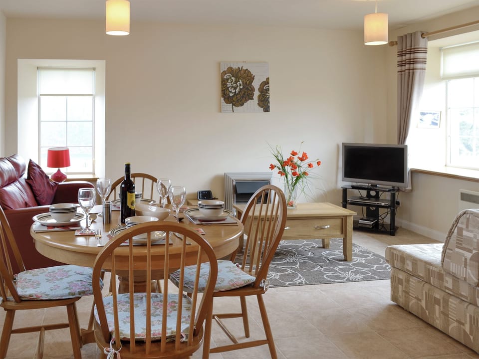 Convenient dining area within an open plan living space | Pennan Lodge - Nethermill Cottages, Pennan, near New Aberdour