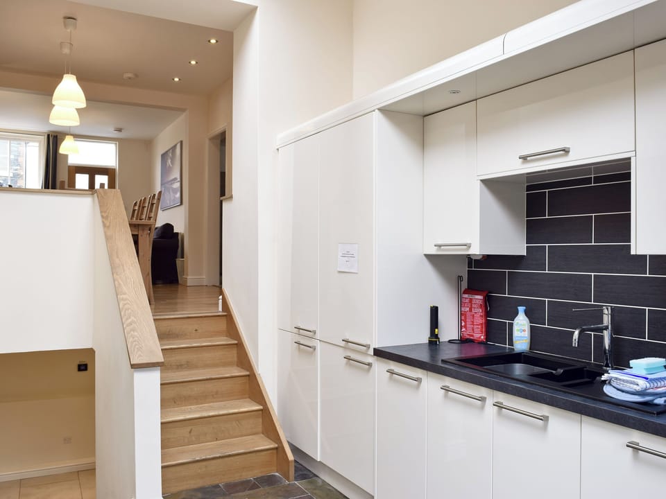 Fitted kitchen with stairs down to lower level | Falcon Crag, Keswick