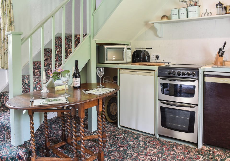 Kitchen and modest dining area | Cerne Abbey Cottage, Cerne Abbas