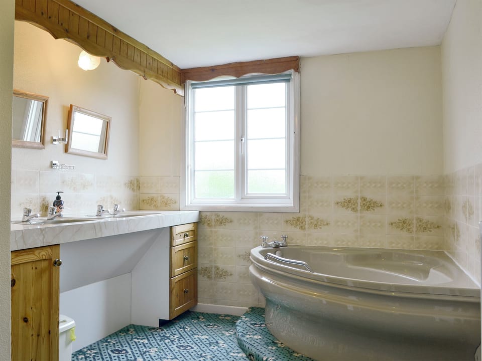 Bathroom with corner bath | The Coach House, Craven Arms
