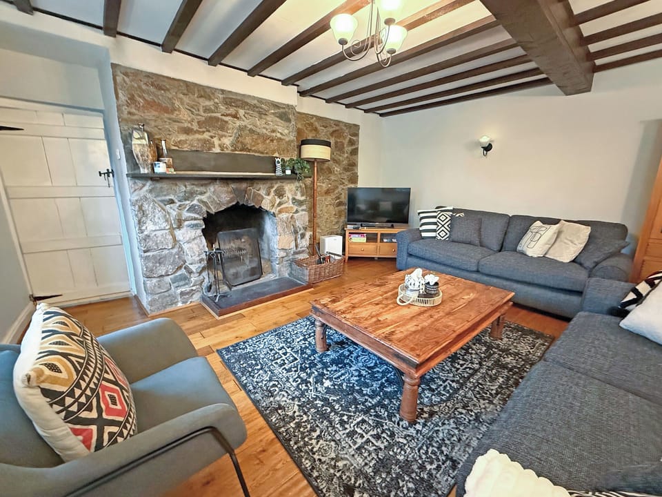 Living room with open fire | Old Tan Rhiw, Beddgelert
