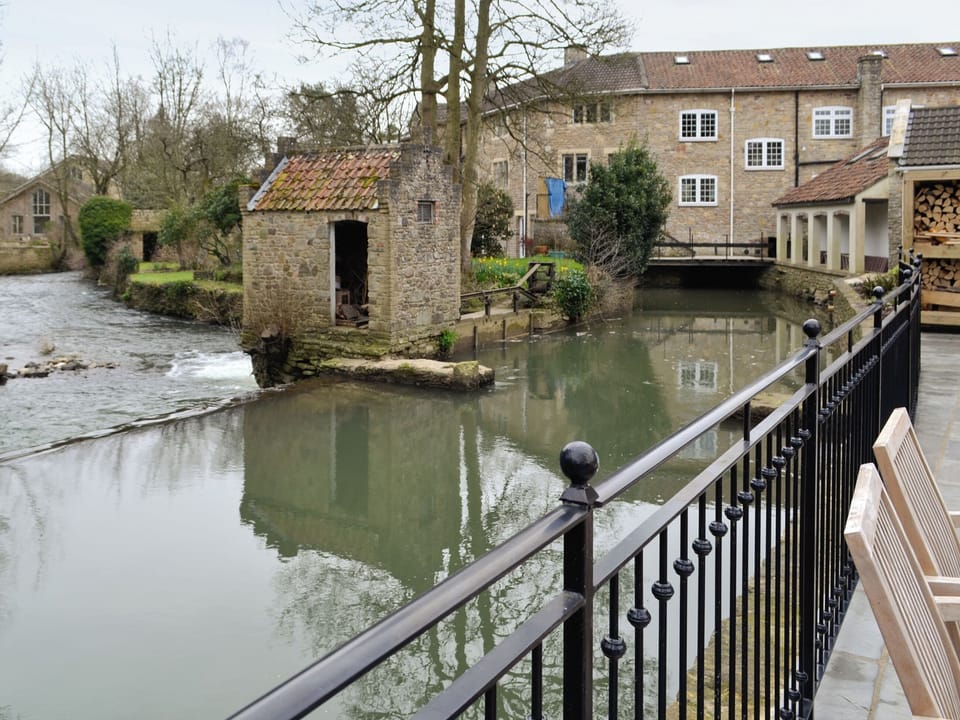 Terrace overlooking river and weir | Herons&rsquo; Weir - Jeffries Mill Cottages, Spring Gardens, Frome