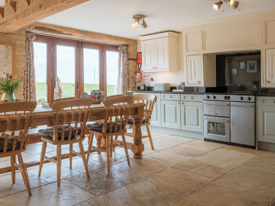 Kitchen diner with patio doors out to the garden | Mortar Barn, Sneatonthorpe, near Whitby