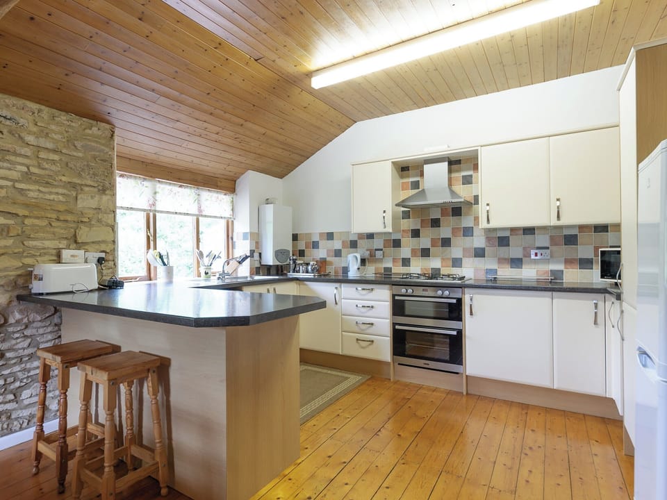 Well-equipped fitted kitchen with breakfast bar | The Mill House, Lea, near Ross-on-Wye