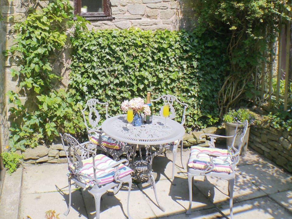 Enclosed courtyard with outdoor furniture | Gable Cottage, Onecote, near Leek