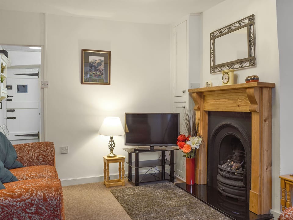 Lovely living room with real flame gas fire in feature fireplace | Laal Yan, Keswick