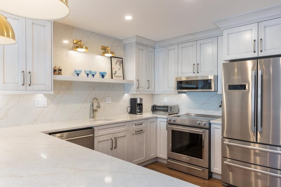 Modern kitchen with sleek stainless steel appliances and bright countertops