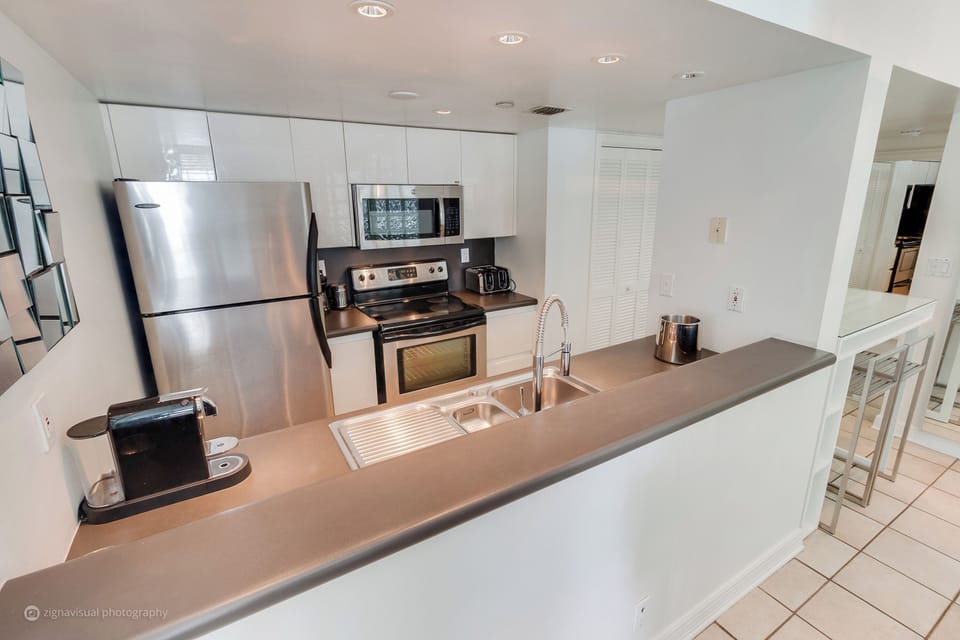 Indulge in our fully equipped kitchen featuring state-of-the-art Vitamix, Nespresso & Keurig Coffee Makers, Soda Stream, full-size stove, oven, microwave, fridge, dishwasher, and laundry machine with dryer.
