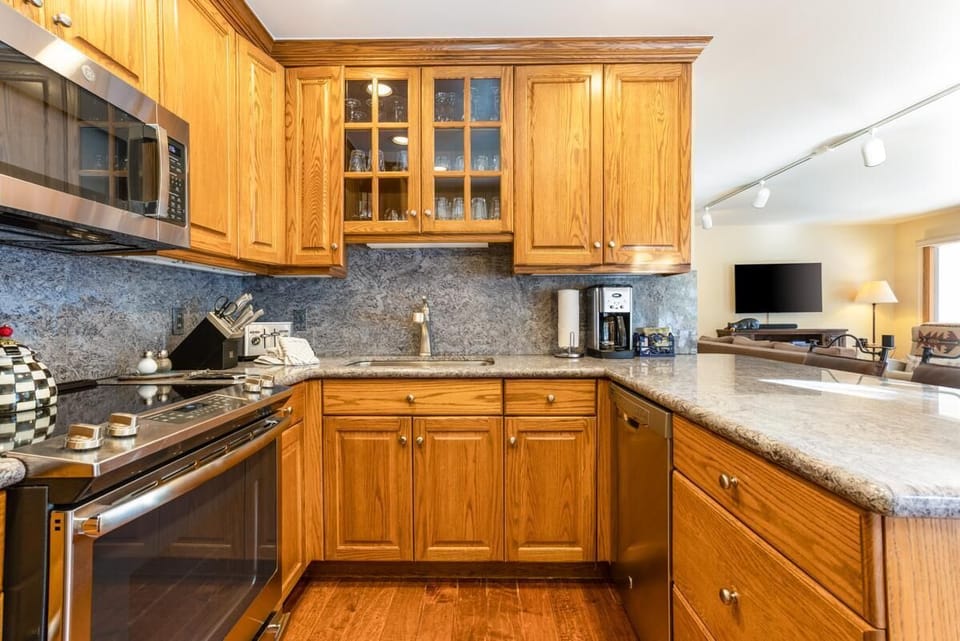 Cozy kitchen with warm wood cabinets and modern appliances