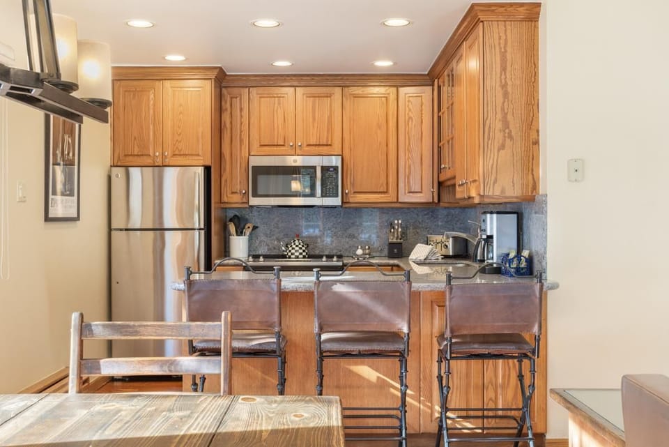 Cozy kitchen with warm wood cabinetry and modern appliances