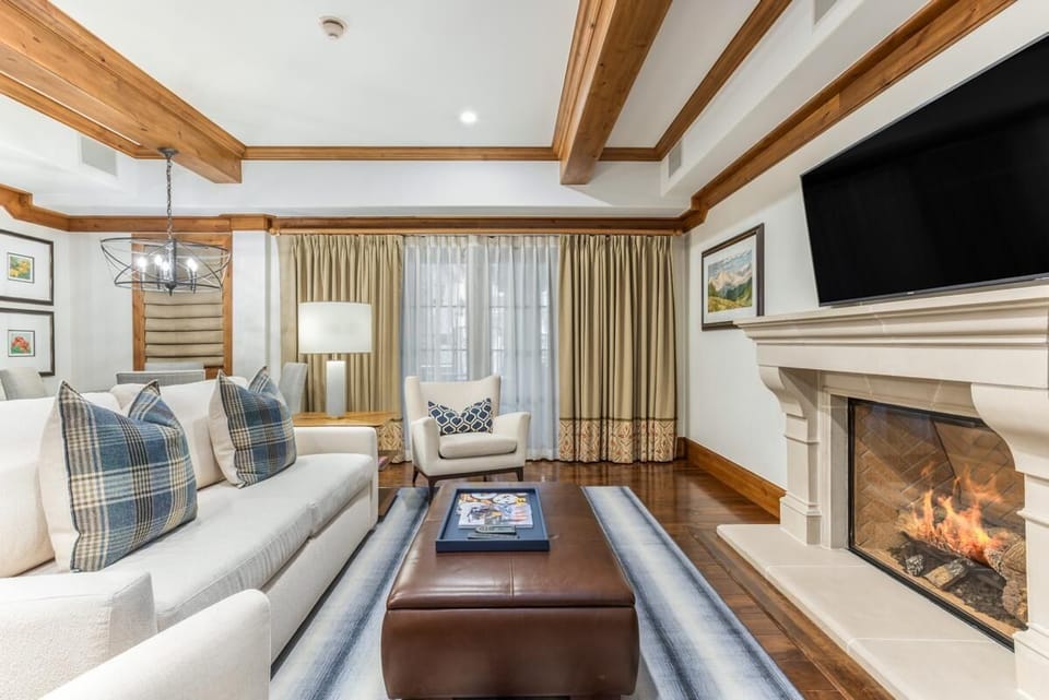 Cozy living room with fireplace and elegant wood beams
