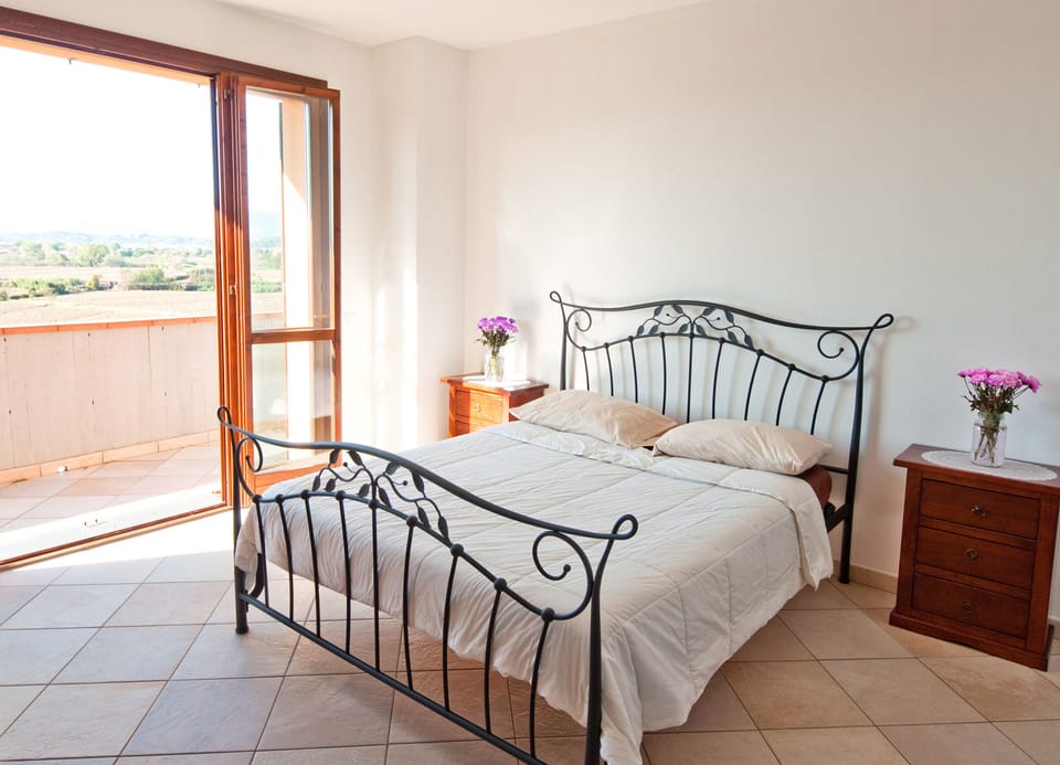 Master bedroom with a balcony and view of the valley