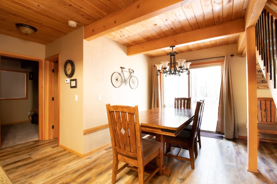 Dining Area- dining table has a bench on one side and extends out to fit 10