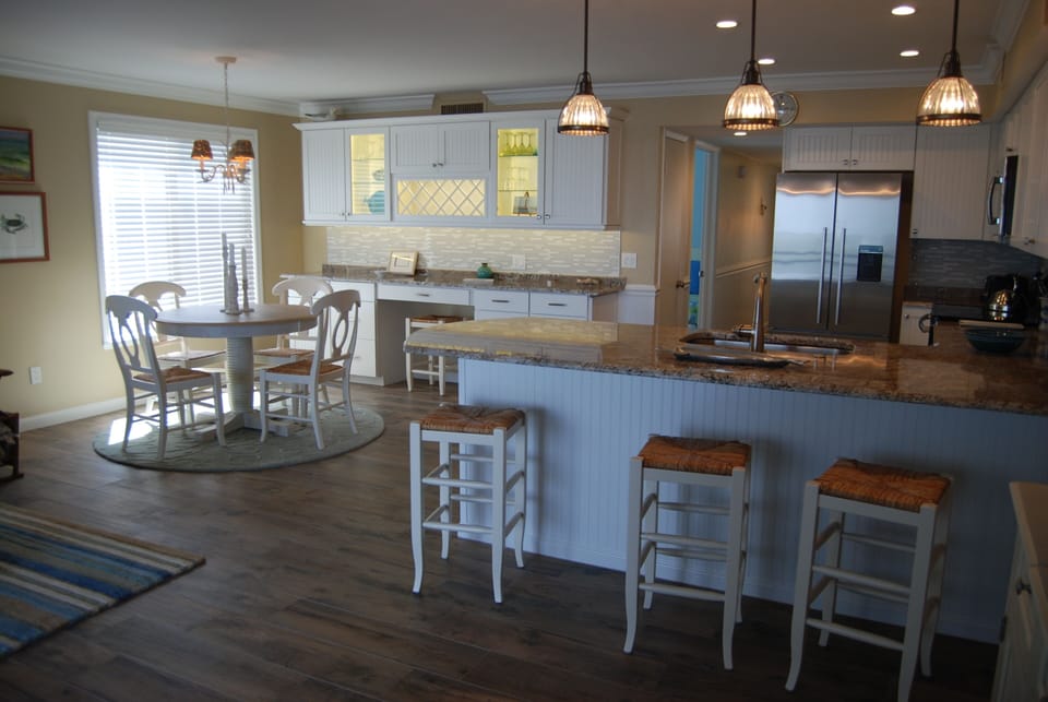 The granite kitchen island has plenty of seating for meals or entertaining.