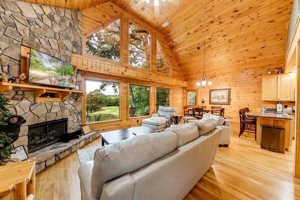 Rock fireplace & large picture windows in open plan living area