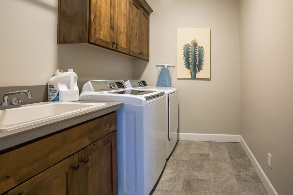 Spacious laundry room with contemporary appliances