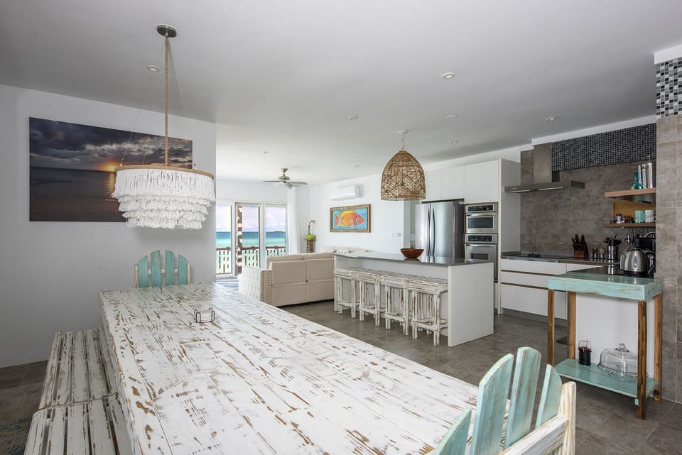 The kitchen, dining area, and breakfast nook offer extensive beach and ocean views