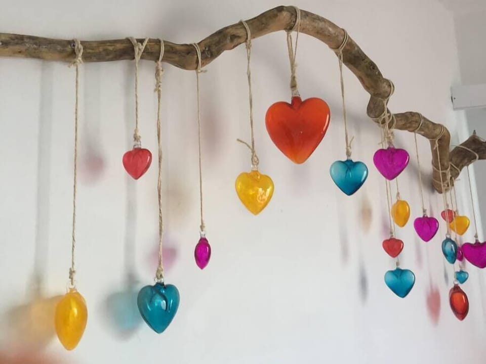 Beautiful and romantic blown glass heart wall hanging in MBR.