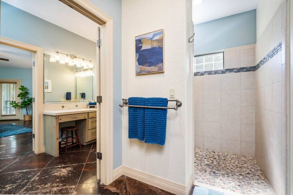 Spacious master bath with walk-in shower and dual vanities for a stress-free stay