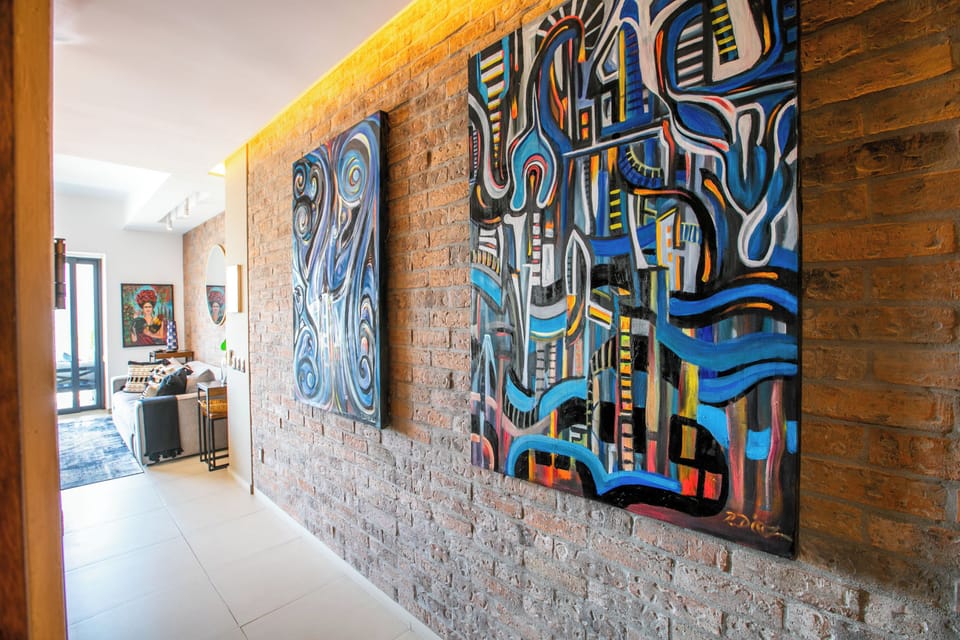 Vibrant artwork adds character to the bright hallway, setting a creative and welcoming tone as you arrive.