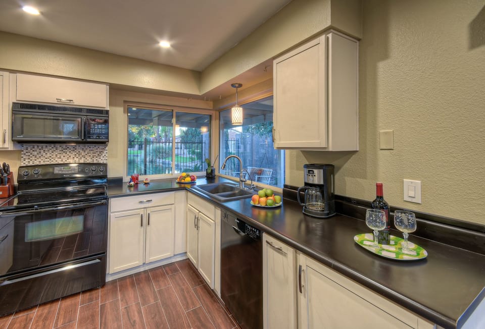 Kitchen is completely stocked for preparing and serving favorite meals and drinks.