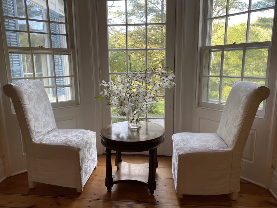 Extra table and chairs by the window in the dining room