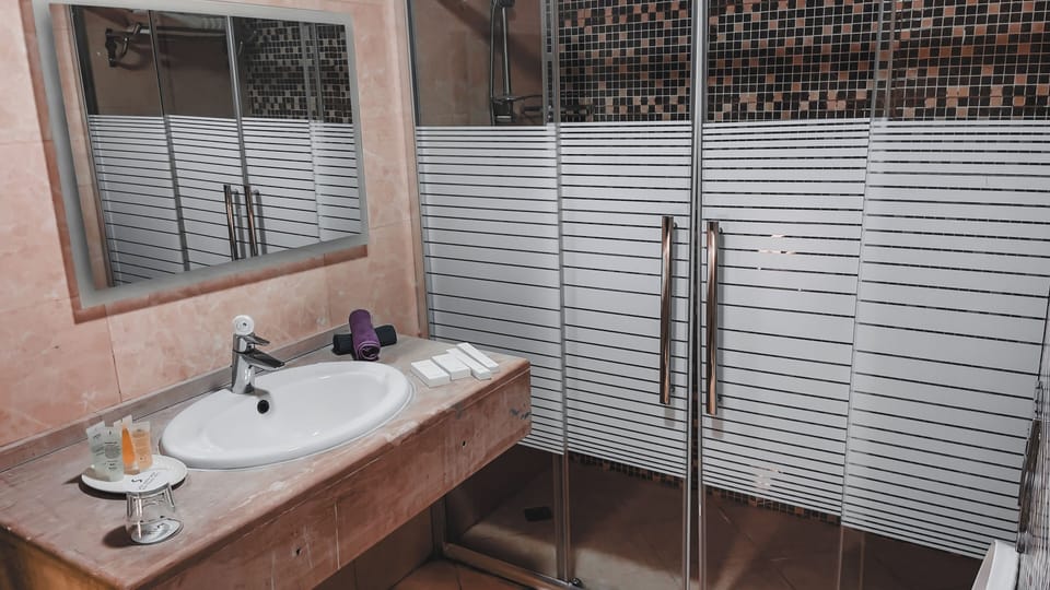 Shower, rainfall showerhead, designer toiletries, hair dryer
