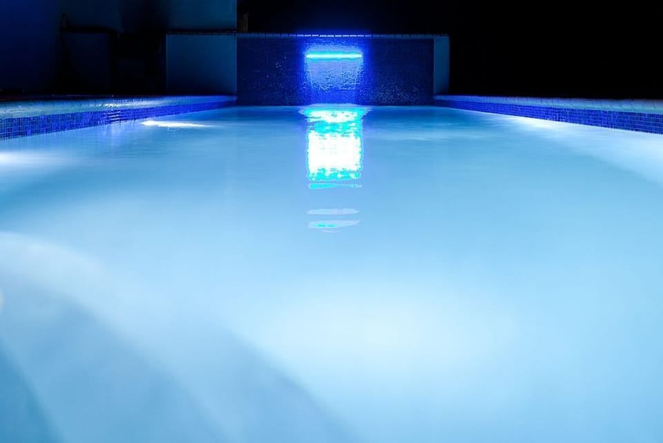 The relaxing pool water fall at night