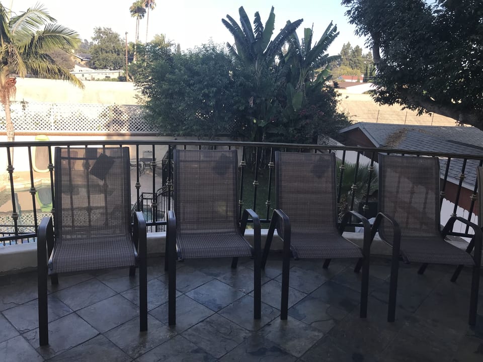 Private patio looking out to the pool, and backyard area