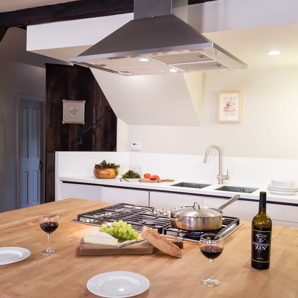 Featuring a Miele five-burner gas range set into a butcher block island