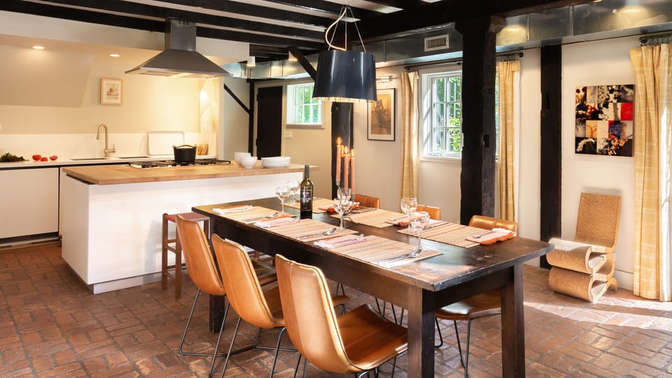 The great room dining area features a farm table that seats 6