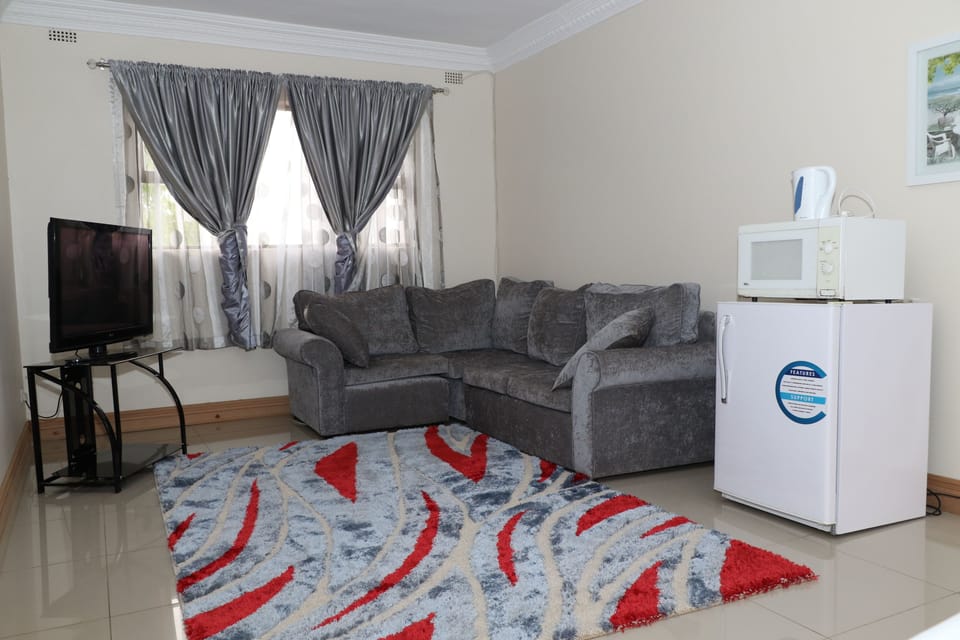 Family Apartment, 2 Queen Beds, Pool View | Living area | Flat-screen TV