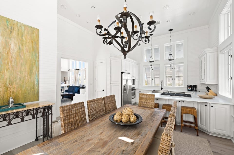 Grand Dining Room with Natural Lighting, Designer Chandelier, and High-Volume Beamed Ceilings