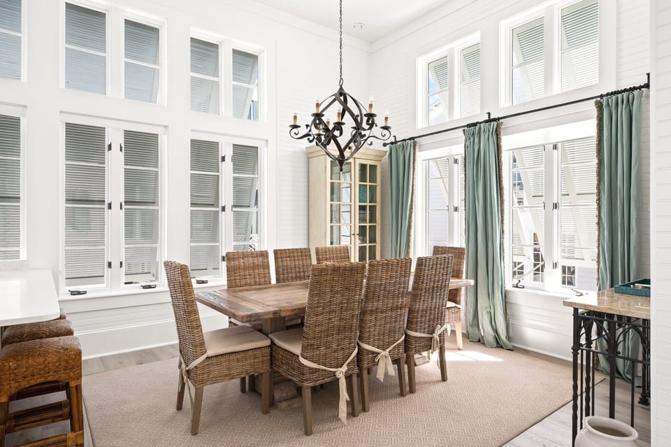 Grand Dining Room with Natural Lighting, Designer Chandelier, and High-Volume Beamed Ceilings