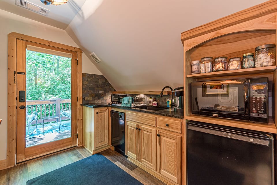 Kitchenette includes a dishwasher & two burner stovetop. PLEASE NOTE: No oven