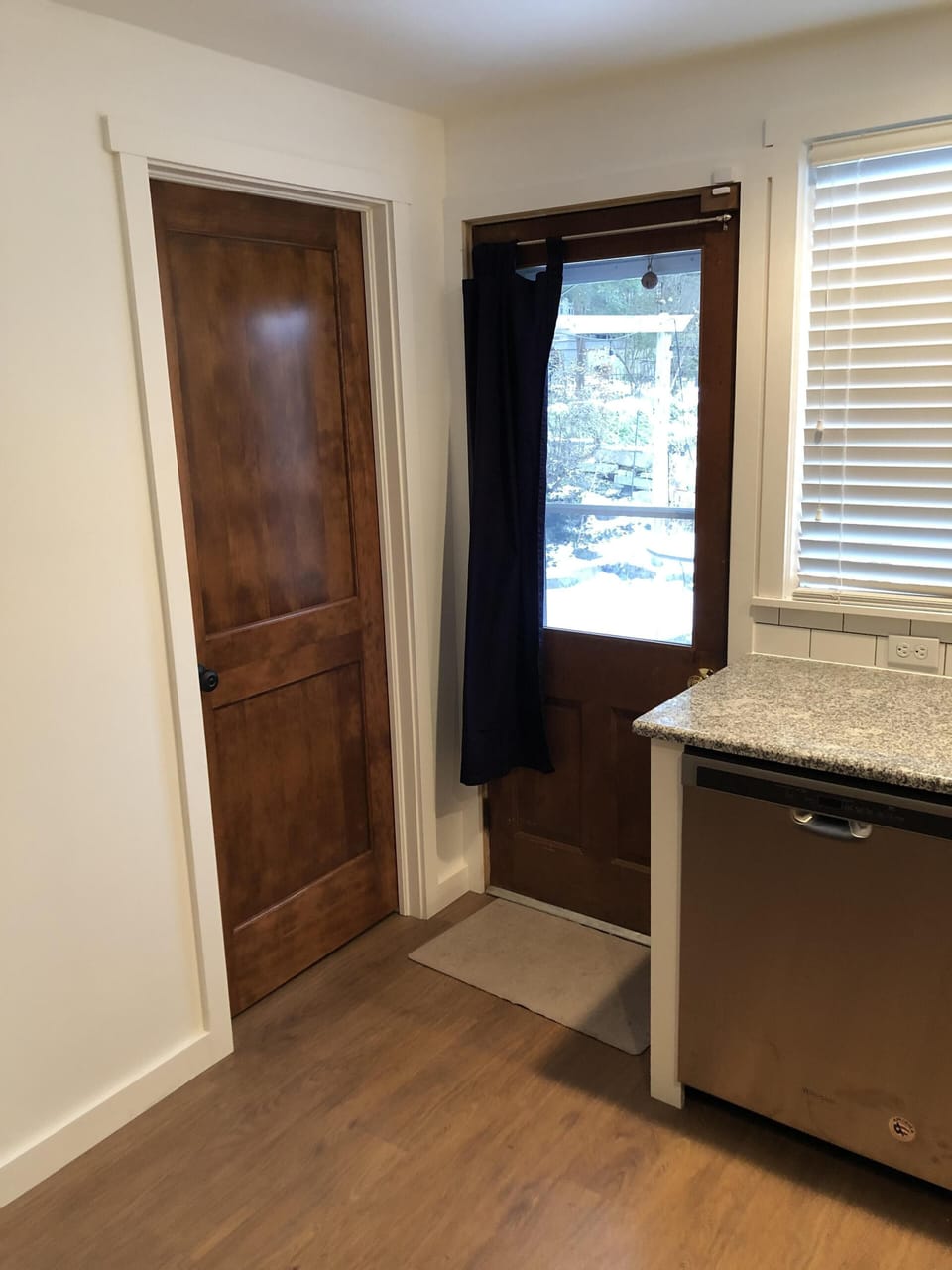 Back entrance, leading to outdoor patio area, and first floor bathroom entrance