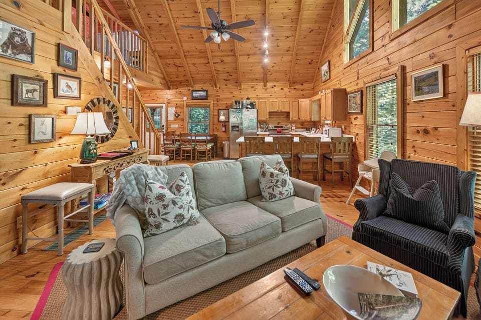 Charming open-plan living area with cozy seating and rustic wood accents.
