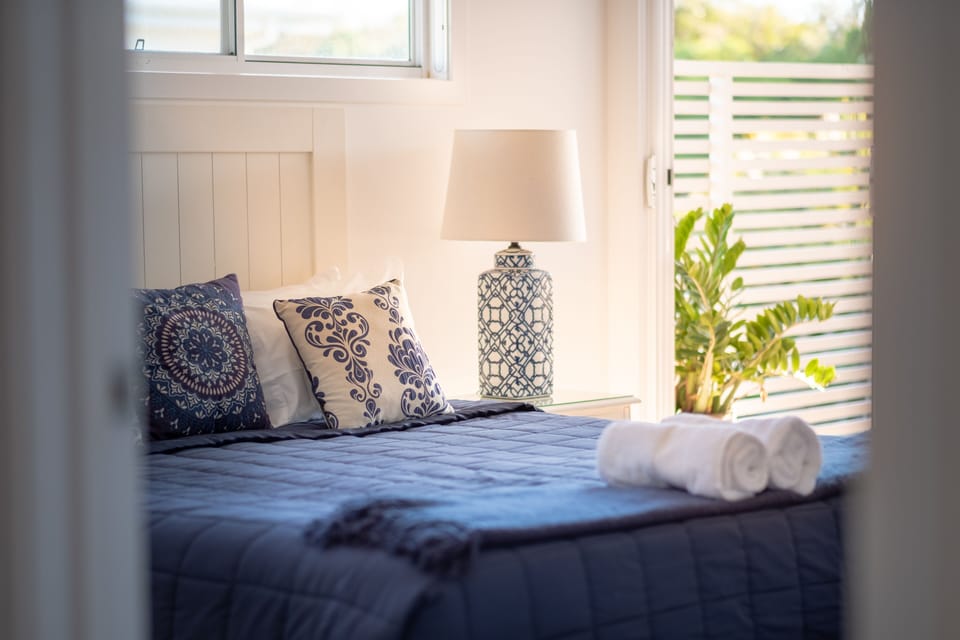 Main Bedroom En Suite with walk in Robe and door to deck area