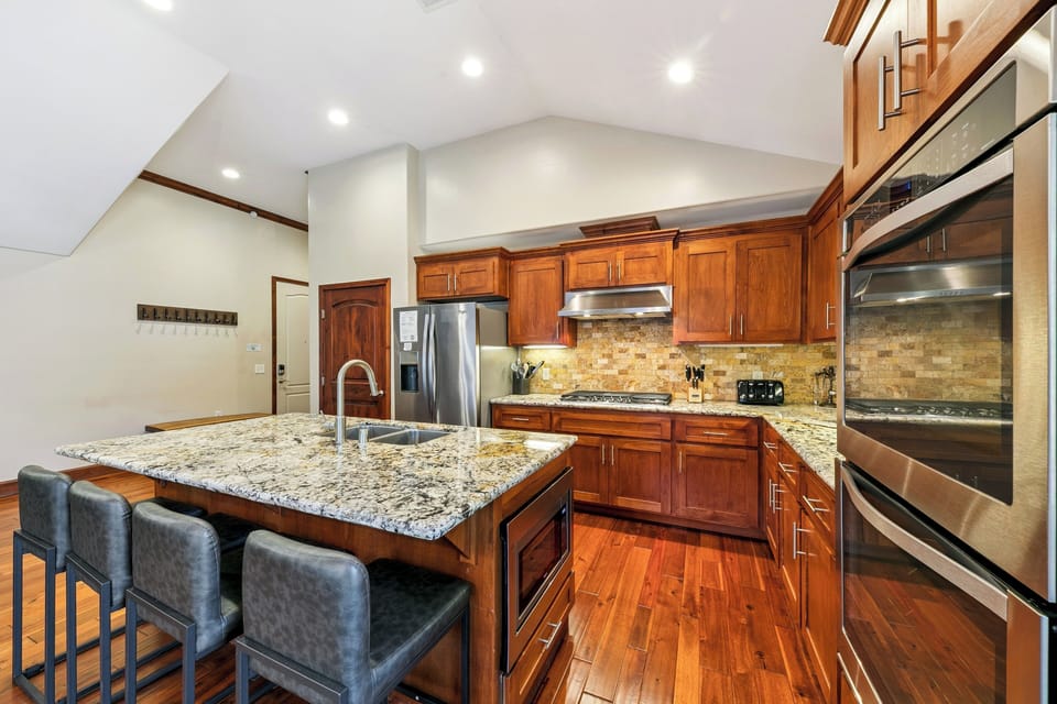 Cook with ease in your spacious kitchen featuring granite counters, stainless appliances, and warm wood cabinetry.