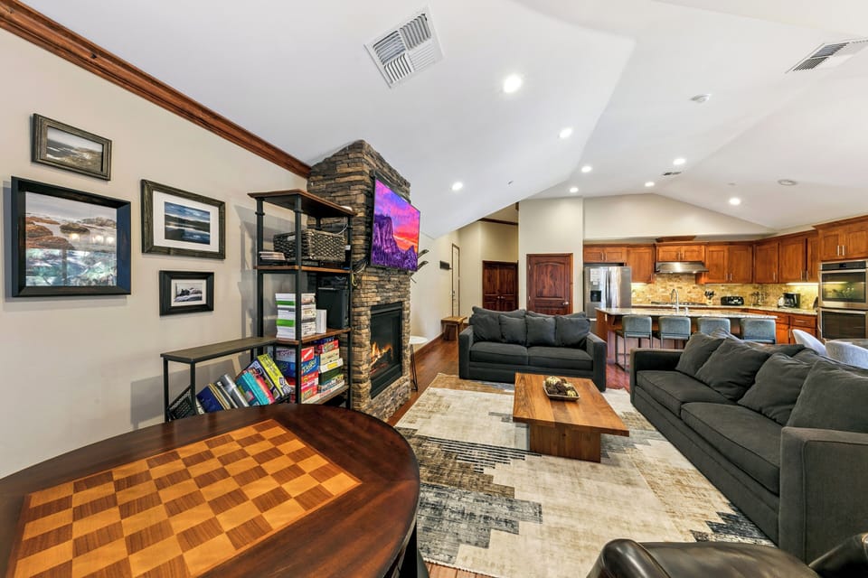 Sink into plush sofas by your stone fireplace while you enjoy games, books, and TV in this inviting open-concept space.