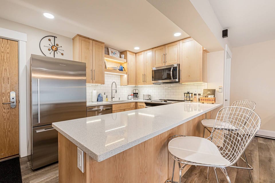 Bright, open kitchen that is fully equipped, ready to prepare shared meals and great conversation.