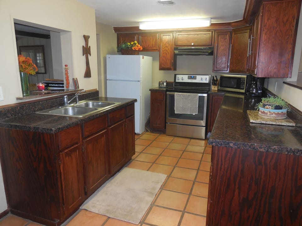 Full kitchen stocked for making meals or preparing a BBQ.