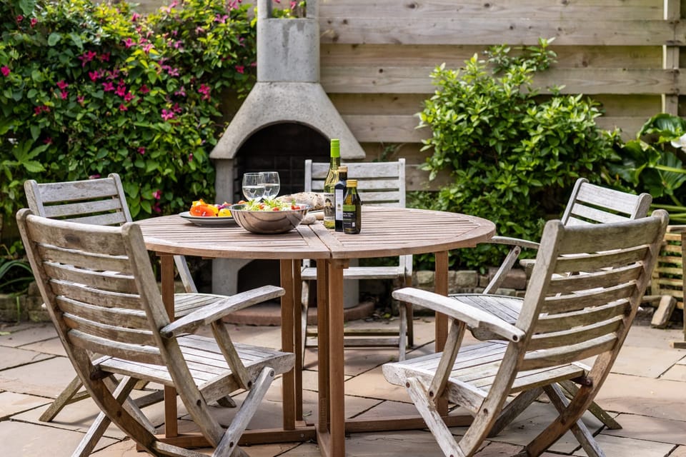 Masonry chiminea in the rear patio, perfect for evening BBQs at large family holiday home in Rhosneigr, Anglesey