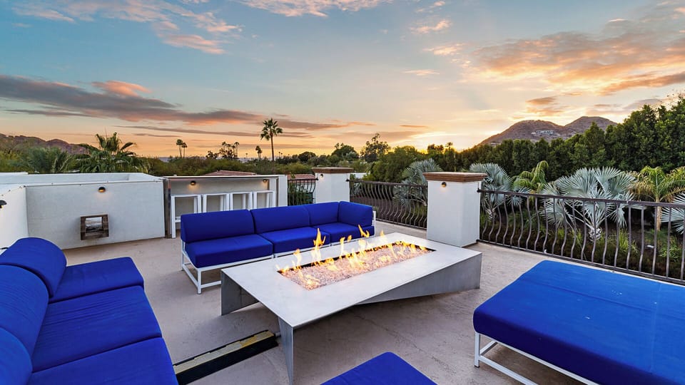 Modern rooftop with fire table, plush seating & stunning sunset views!