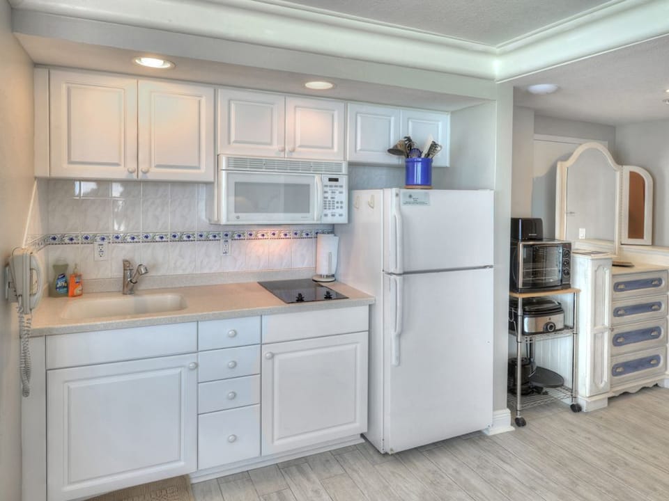 Fully Equipped for Convenience. Everything you need to prep snacks or light meals, including a refrigerator, stovetop, and coffee maker.