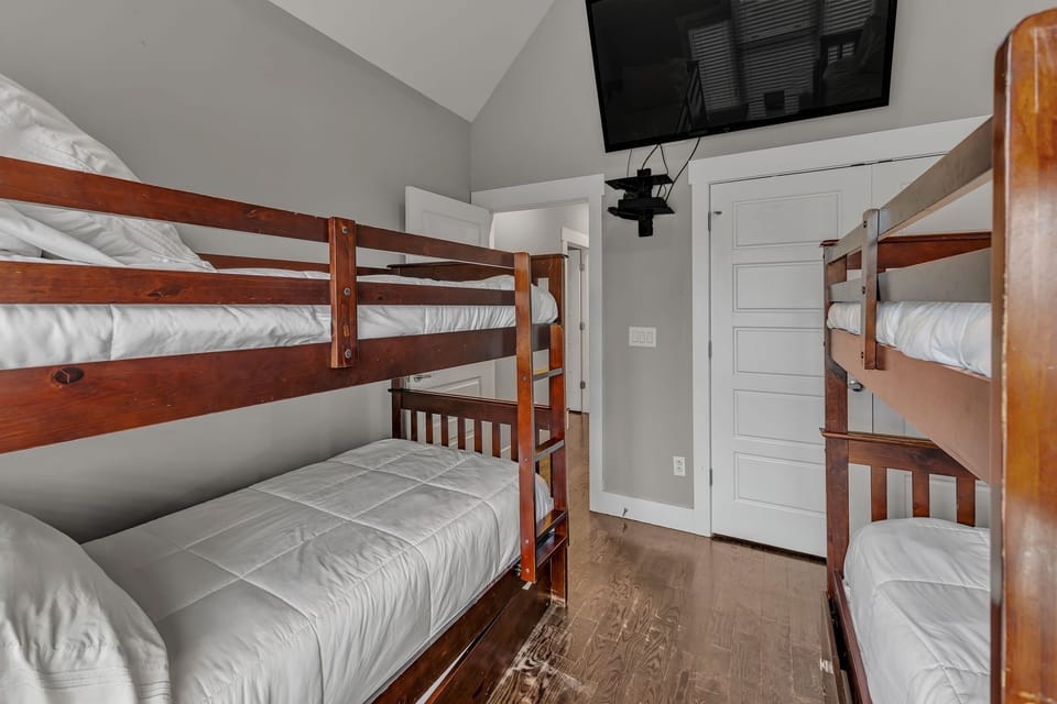 Bunk Room with Full over Full and Twin over Twin beds and 75 inch SmartTV.