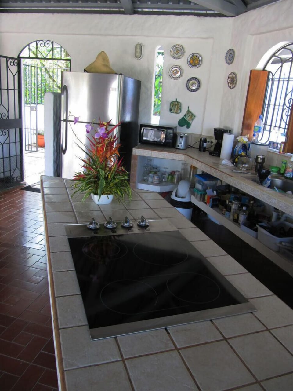 Kitchen counter with main entrance... new stove top and stainless fridge.
