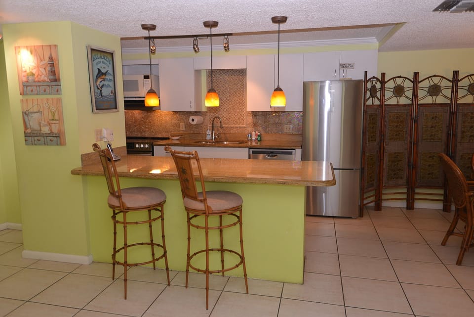 View from hallway of kitchen w/ granite countertops, new stainless appliances